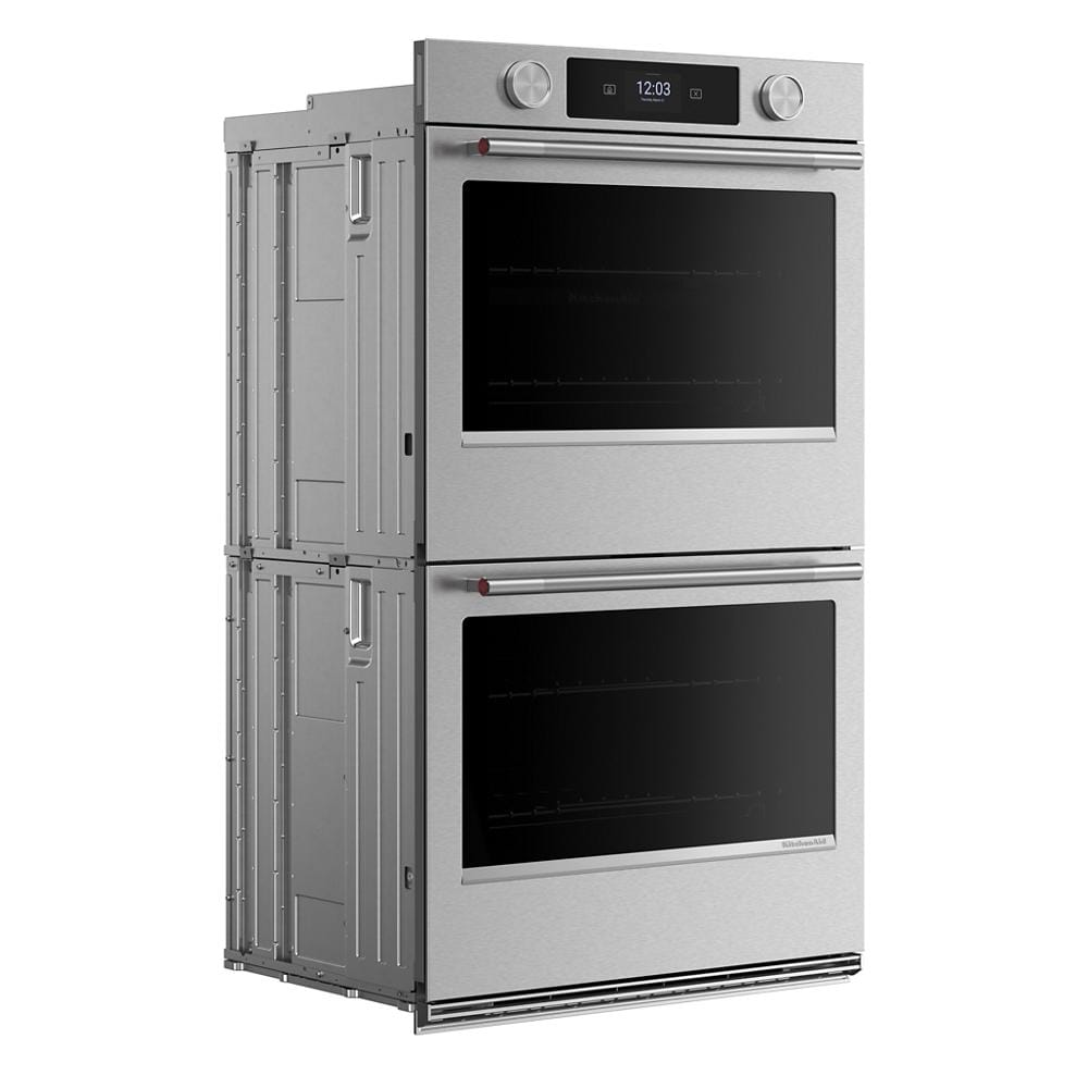 Angled view of a 30-inch smart electric double wall oven in stainless steel with digital display and control knobs, part of KitchenAid appliances for home improvement and kitchenware collections.