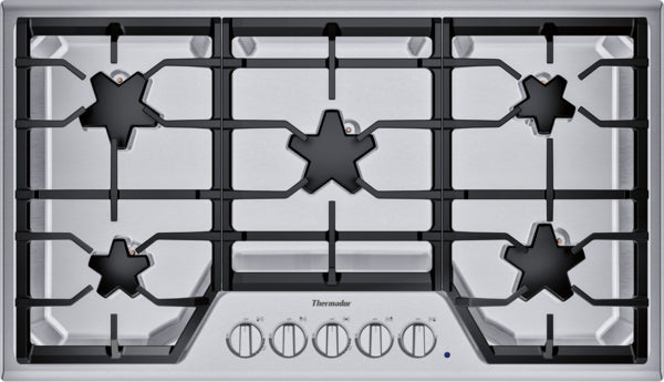 Stainless steel 36-inch gas cooktop with five burners and continuous grates in kitchen appliances collection