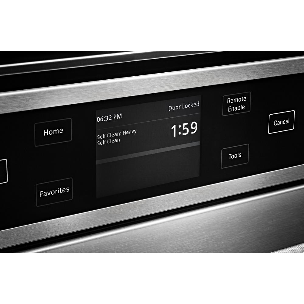 Close-up of stainless steel smart oven control panel showing heavy self-clean cycle and timer countdown