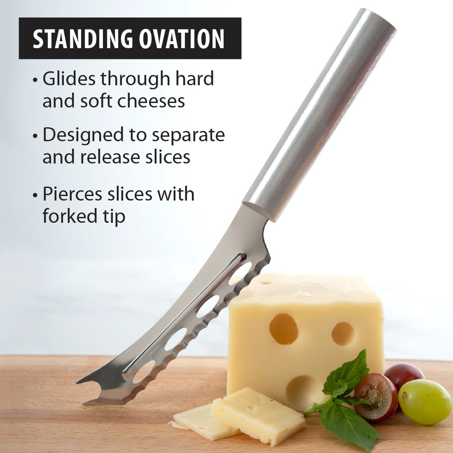 Serrated stainless steel cheese knife with forked tip slicing Swiss cheese on wooden board in kitchen utensils collection