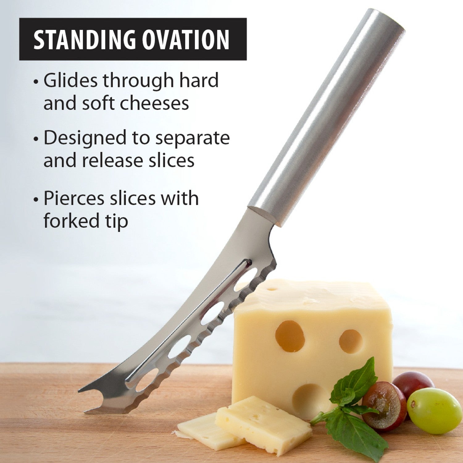 Serrated stainless steel cheese knife with forked tip slicing Swiss cheese on wooden board in kitchen utensils collection