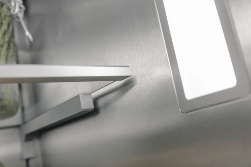 Close-up of interior stainless steel wall and shelf bracket with integrated LED light in high-end refrigerator column from Appliances collection