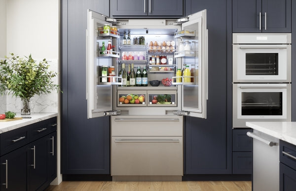 Built-in stainless steel French door refrigerator with bottom freezer in modern kitchen appliances collection