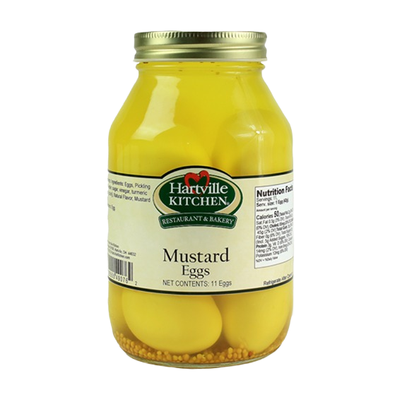 Glass jar of Hartville Kitchen mustard eggs with yellow pickled eggs and visible mustard seeds inside
