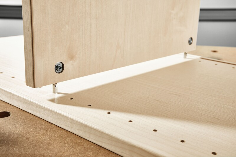Wooden panels connected with metal corner connectors for stable knock-down joinery in woodworking tool accessories.