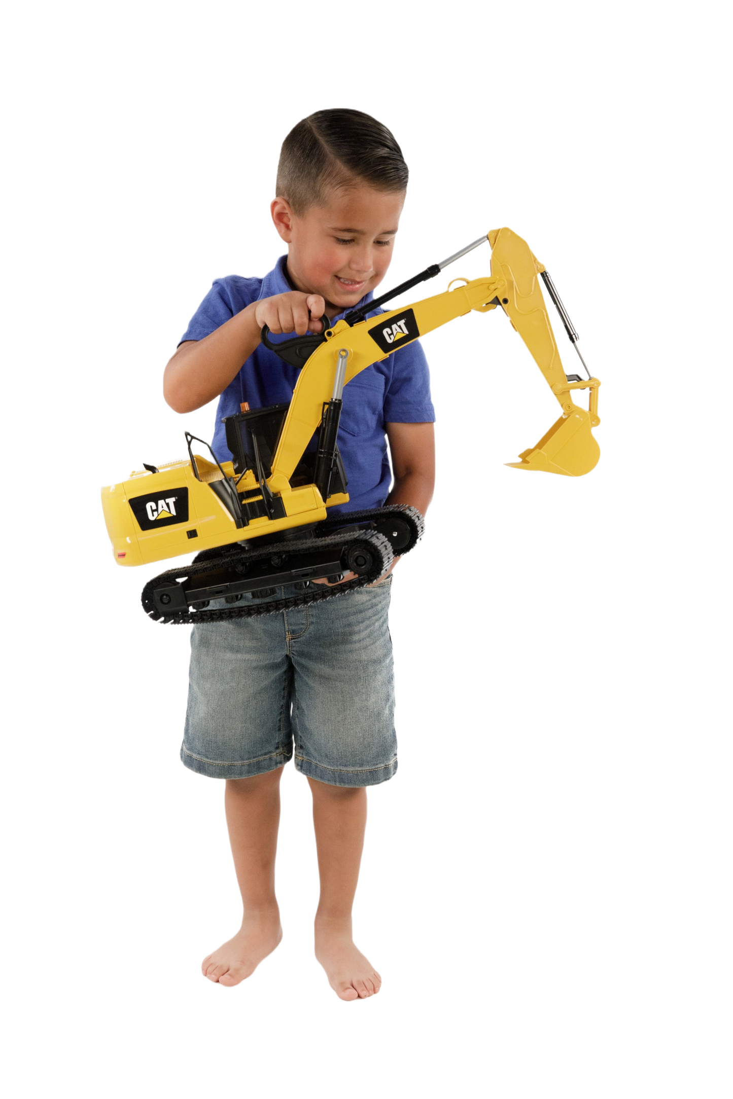 Child playing with a large yellow CAT excavator toy featuring movable arm and bucket on black tracks