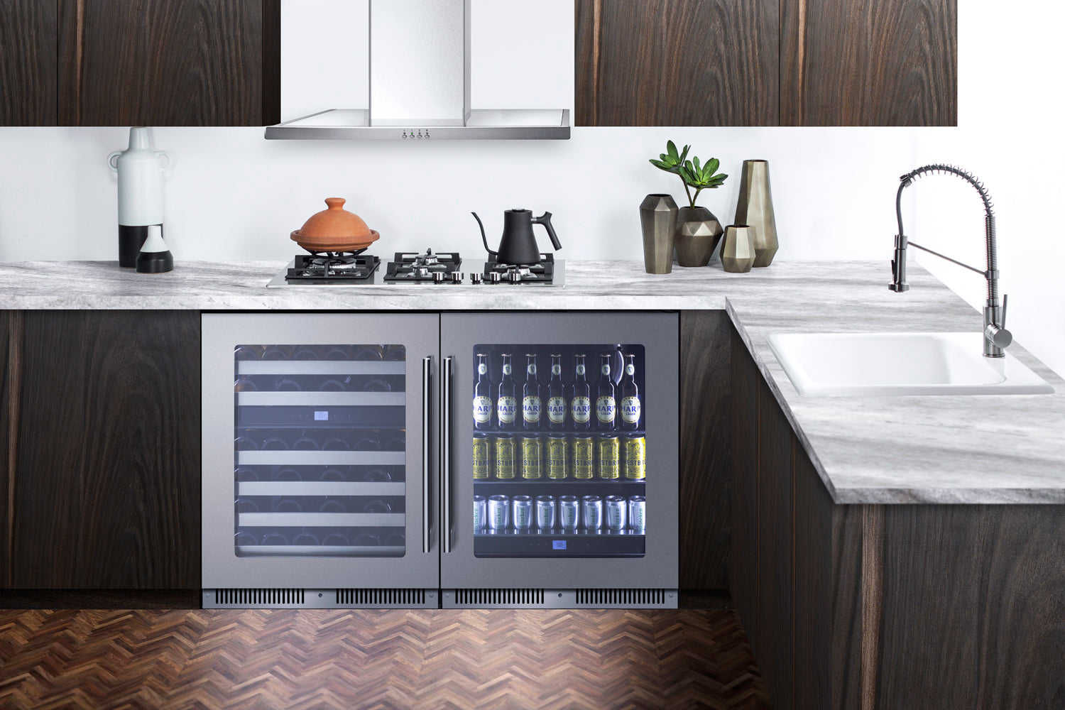 Built-in beverage center with dual glass doors displaying chilled drinks in a modern kitchen with dark wood cabinetry and marble countertop
