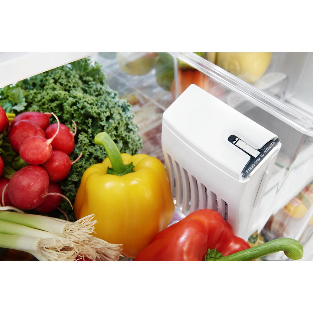 Close-up of fresh vegetables and humidity-controlled crisper drawer inside French door 30-inch refrigerator interior