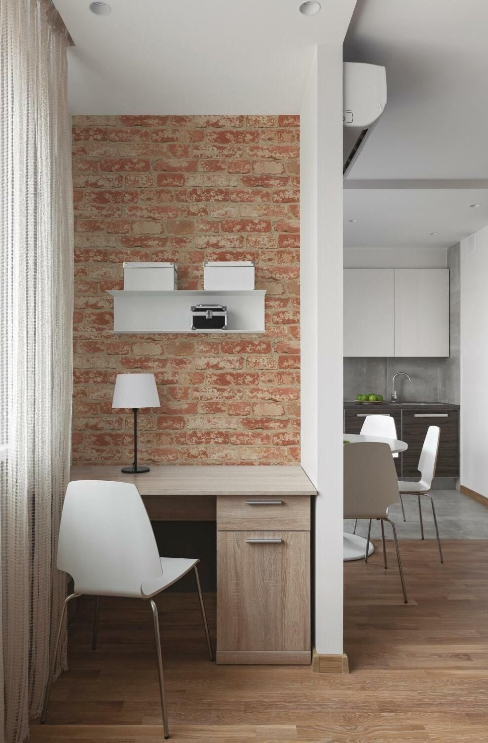Home workspace with wooden desk and lamp against stuccoed brick peel and stick wallpaper in modern apartment interior