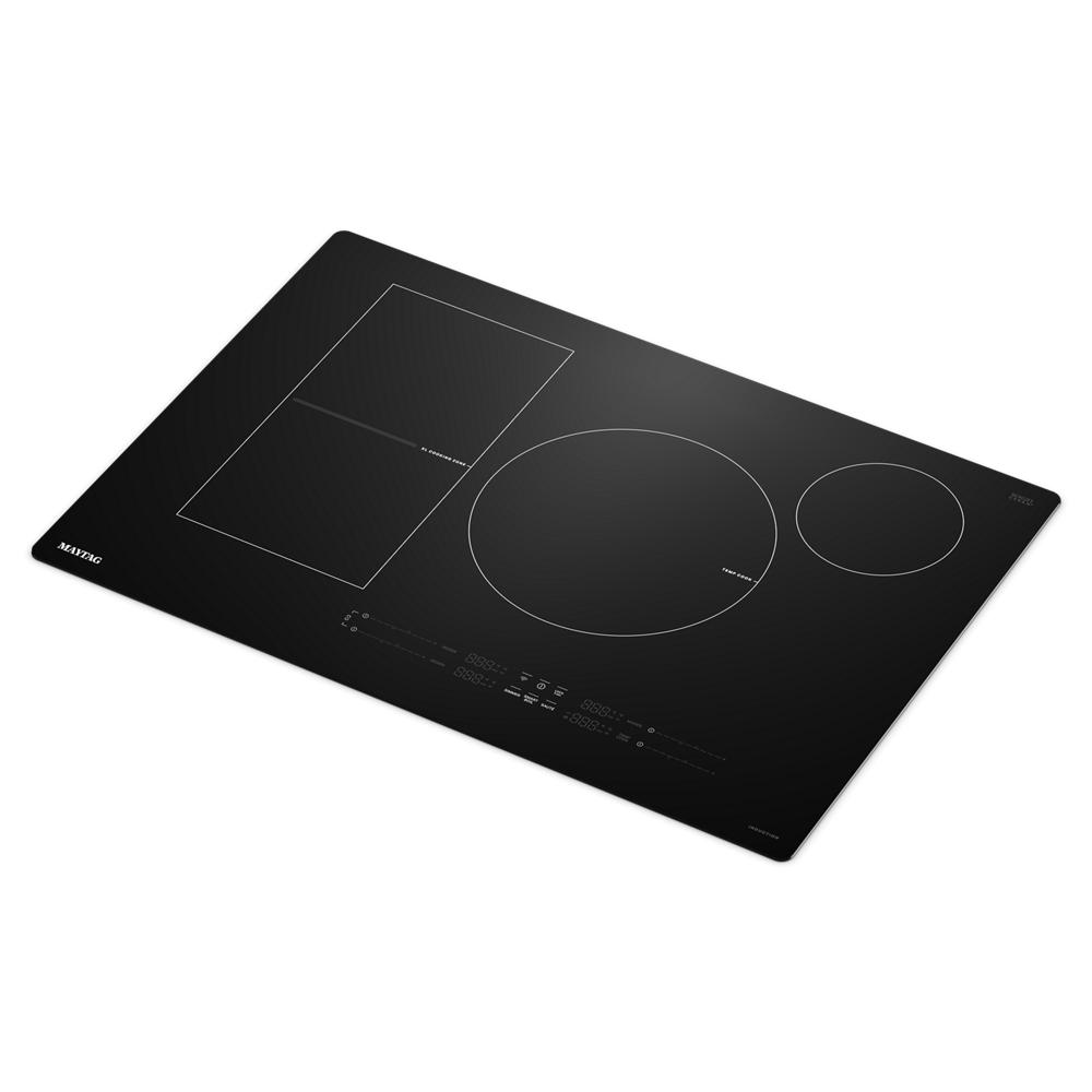 Black glass induction cooktop with three cooking zones and digital touch controls in kitchen appliances collection