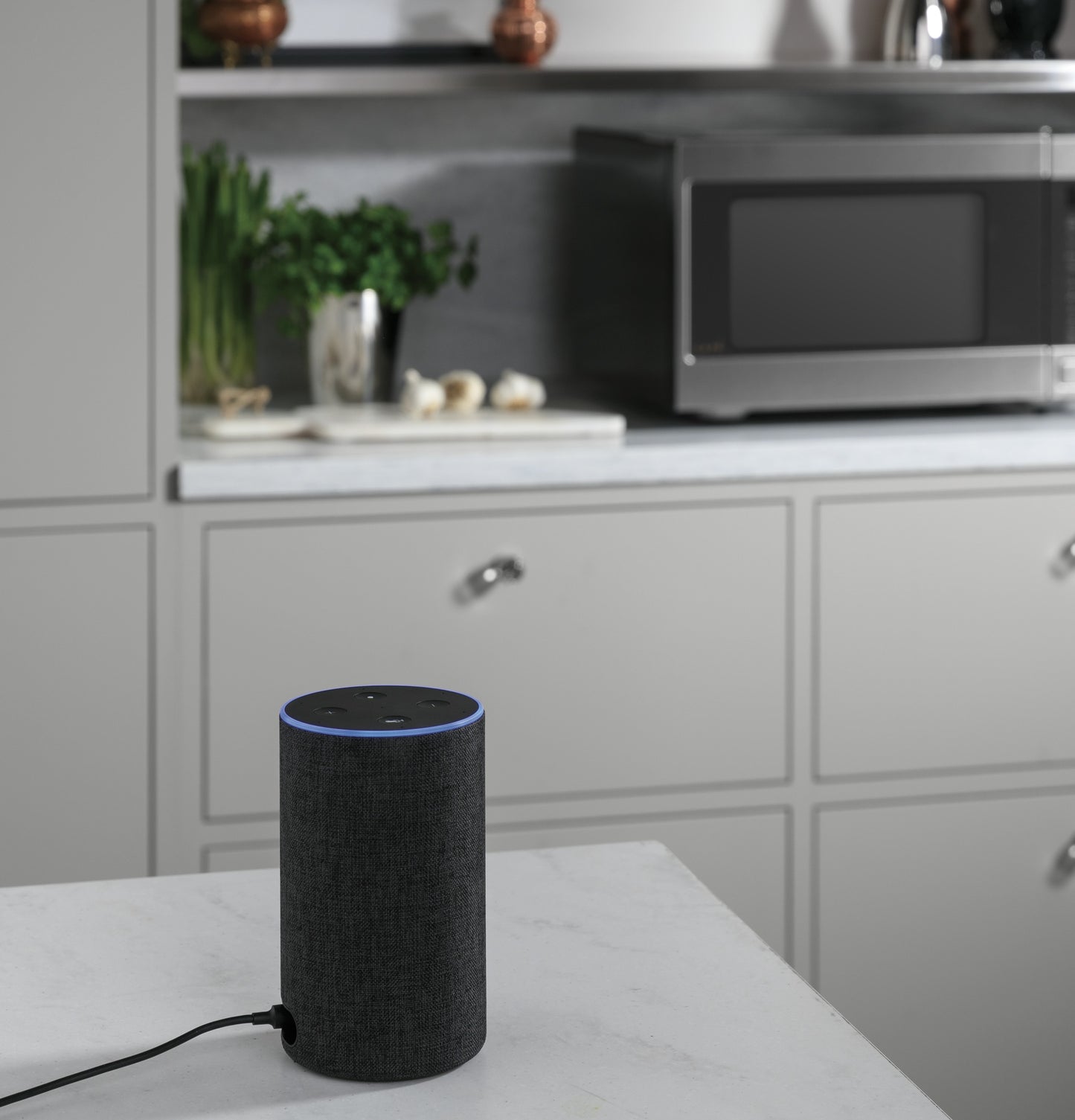 Smart speaker with fabric cover on white kitchen countertop near microwave in Kitchen & Kitchenware collection