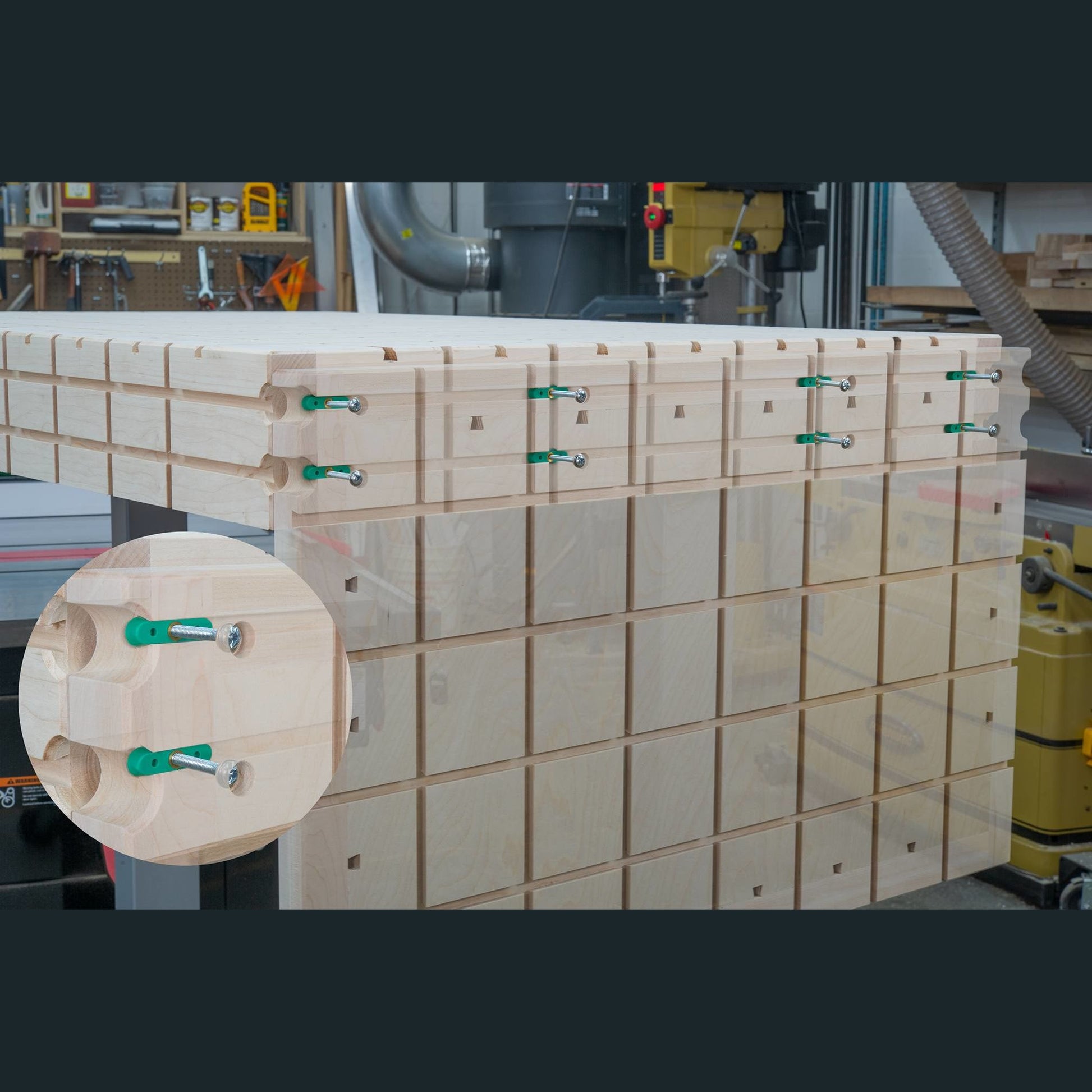 Wooden boards joined using green dovetail hardware clamps for woodworking and tool accessory projects in workshop setting