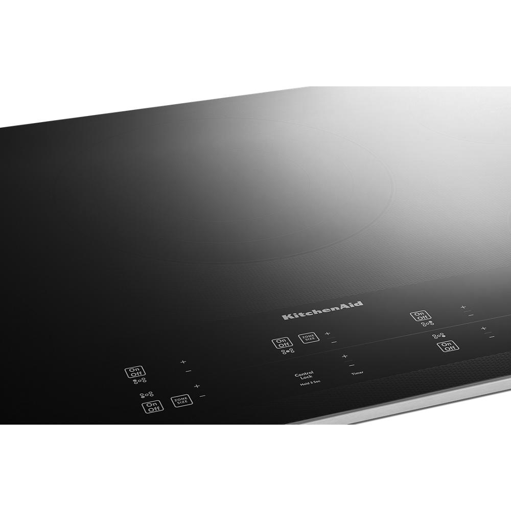 Black glass cooktop featuring five touch-activated controls with sleek design from KitchenAid appliances collection