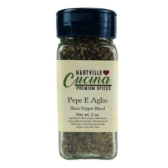 Glass spice jar filled with coarse black pepper blend, featuring a black lid and labeled Hartville Cucina premium spices