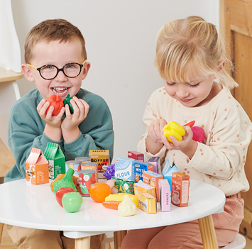 Children playing with colorful toy fruits, vegetables, and grocery items for pretend play in Toys & Games collection