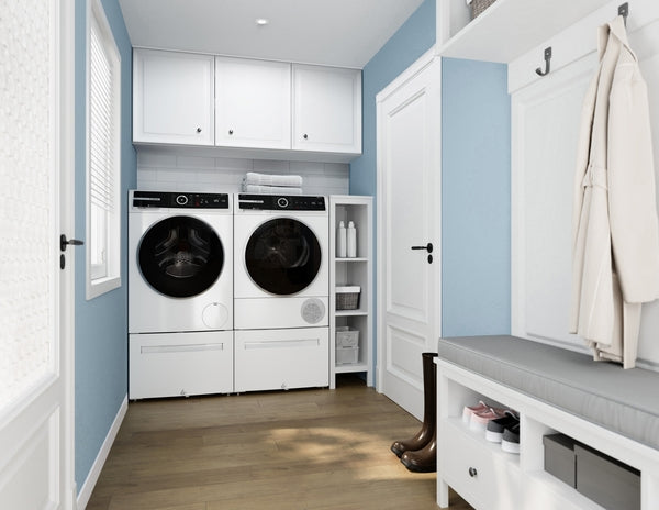 White front load washer and dryer set in modern laundry room with blue walls and wood flooring