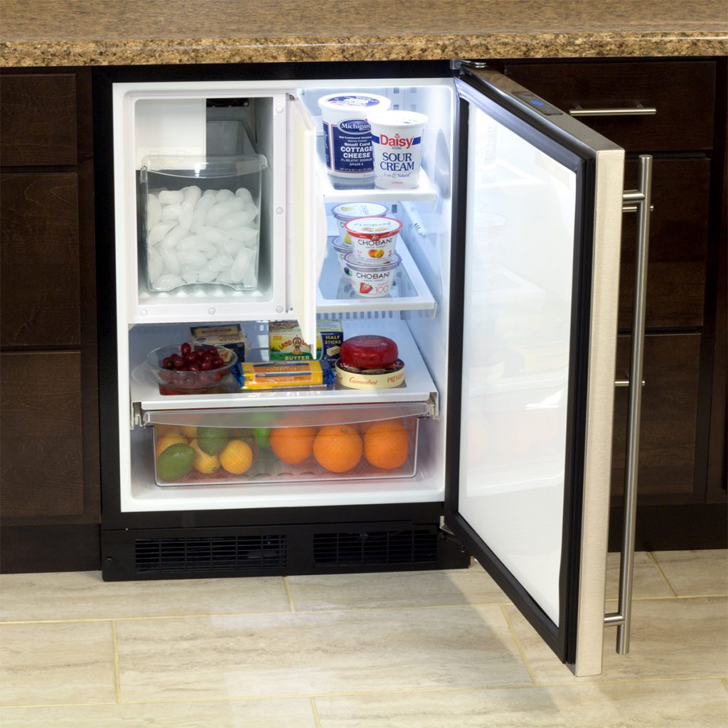 Undercounter refrigerator with ice maker, adjustable shelves, drawer storage filled with fruit and dairy from appliances collection