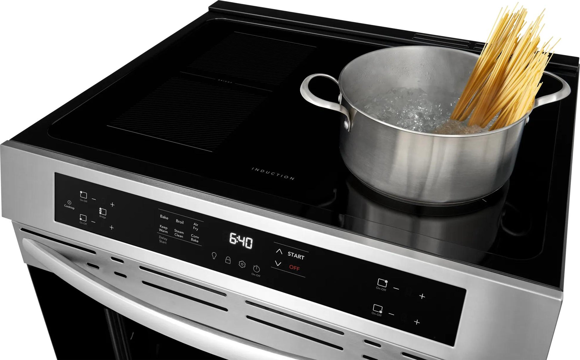 Stainless steel induction cooktop with digital front controls and boiling pot of spaghetti, part of kitchen appliances collection