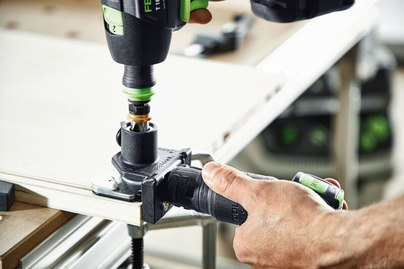 Woodworking drilling template with drill attachment in use on wood panel for woodworking tool accessories collections