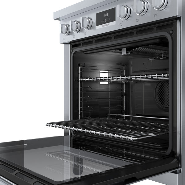 Open stainless steel gas freestanding oven with adjustable racks, digital display, and metal control knobs in kitchen appliances collection