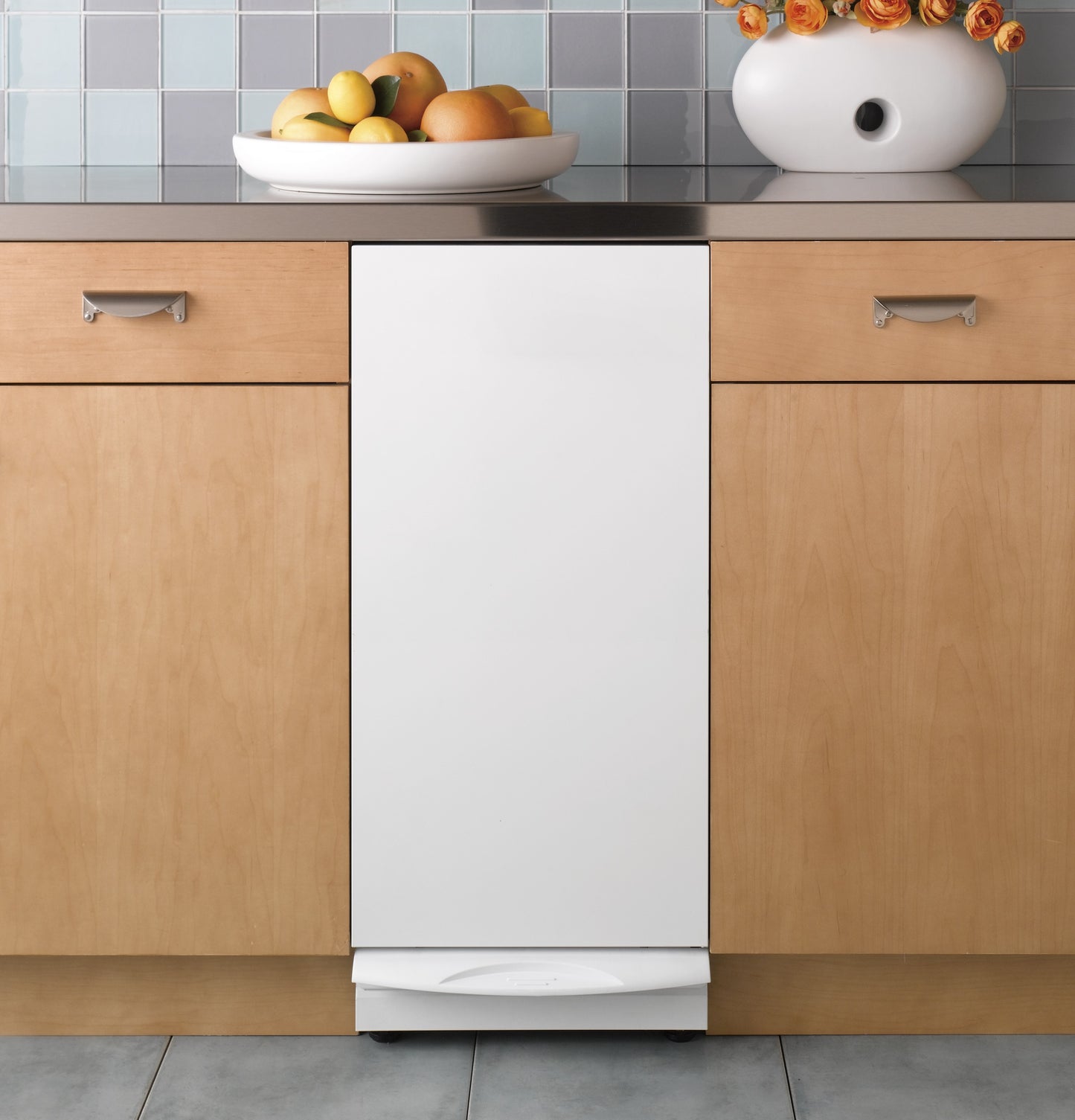 Built-in white trash compactor integrated into natural wood cabinetry in Kitchen & Kitchenware and Appliances collections