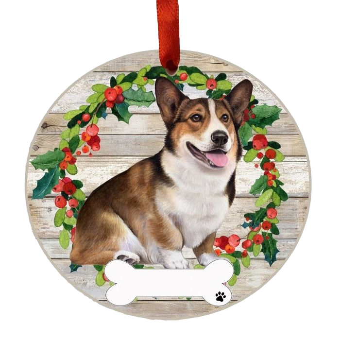 Round Christmas ornament featuring a cheerful Welsh Corgi in front of a holly wreath with a bone tag detail.