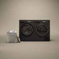 Front view of a black front load washer and matching dryer set with digital controls and a fabric laundry basket, featured in Front Load Washers, Washers, Appliances, All Products, and Washers & Dryers at Hartville Hardware.