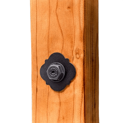 Black decorative washer with floral edges and hex bolt on wood post for lumber and home improvement projects