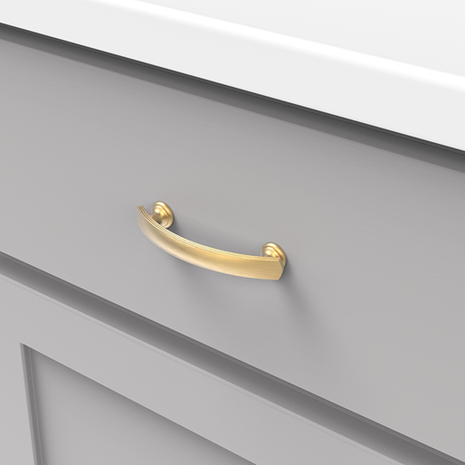 Curved brushed golden brass cabinet pull on gray drawer front for furniture hardware and home improvement projects