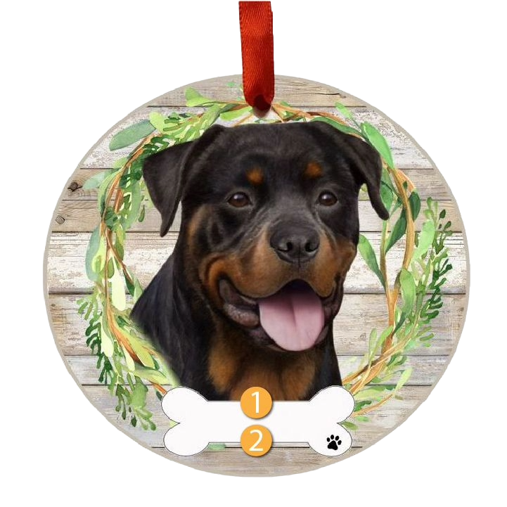 Round Christmas ornament featuring a happy Rottweiler face inside a green wreath on rustic wood background