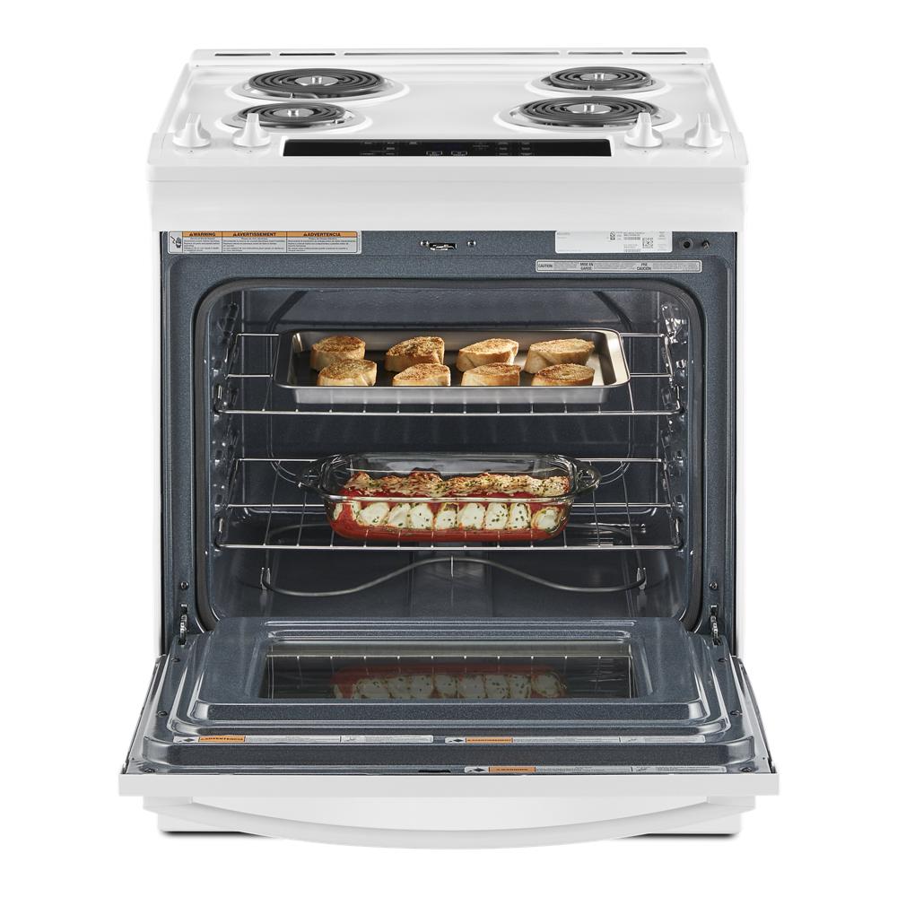 White electric range with four coil burners and open oven door showing baked bread and casserole inside