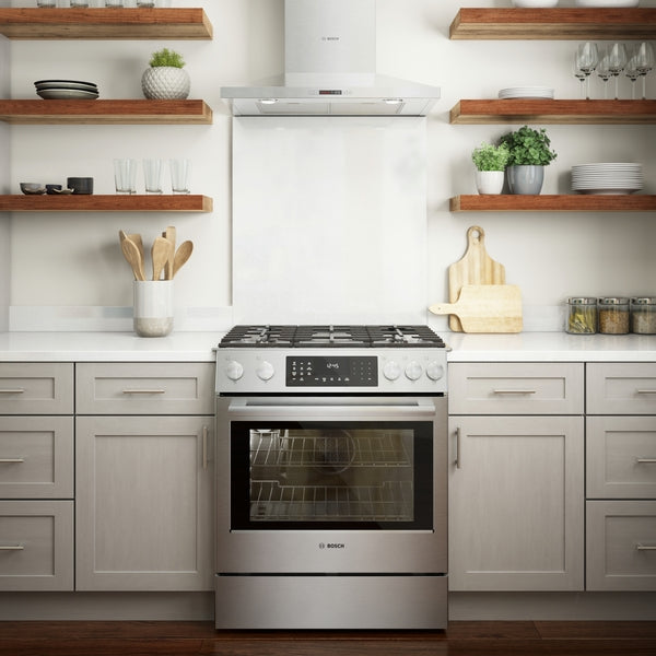 stainless steel dual fuel slide-in range with metal knobs and digital display in modern kitchen setting