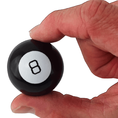 Hand holding a miniature black and white 8-ball toy from the Toys & Games collection under $50