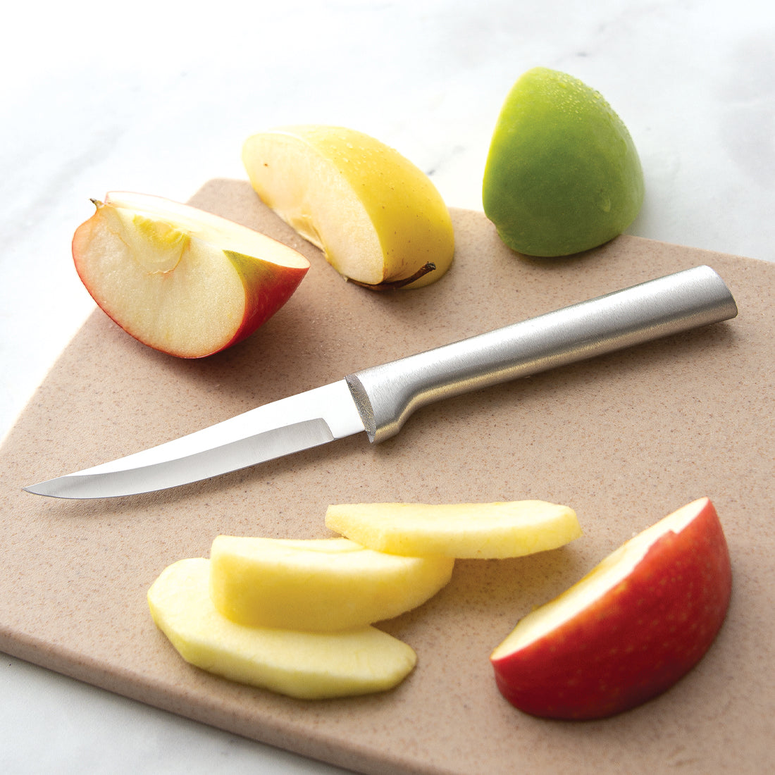 Sleek paring knife with smooth metal handle on cutting board with sliced apple pieces in Kitchenware collections under $50