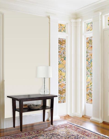 Narrow sidelights with dogwood floral privacy film featuring white blossoms and green branches in a bright entryway
