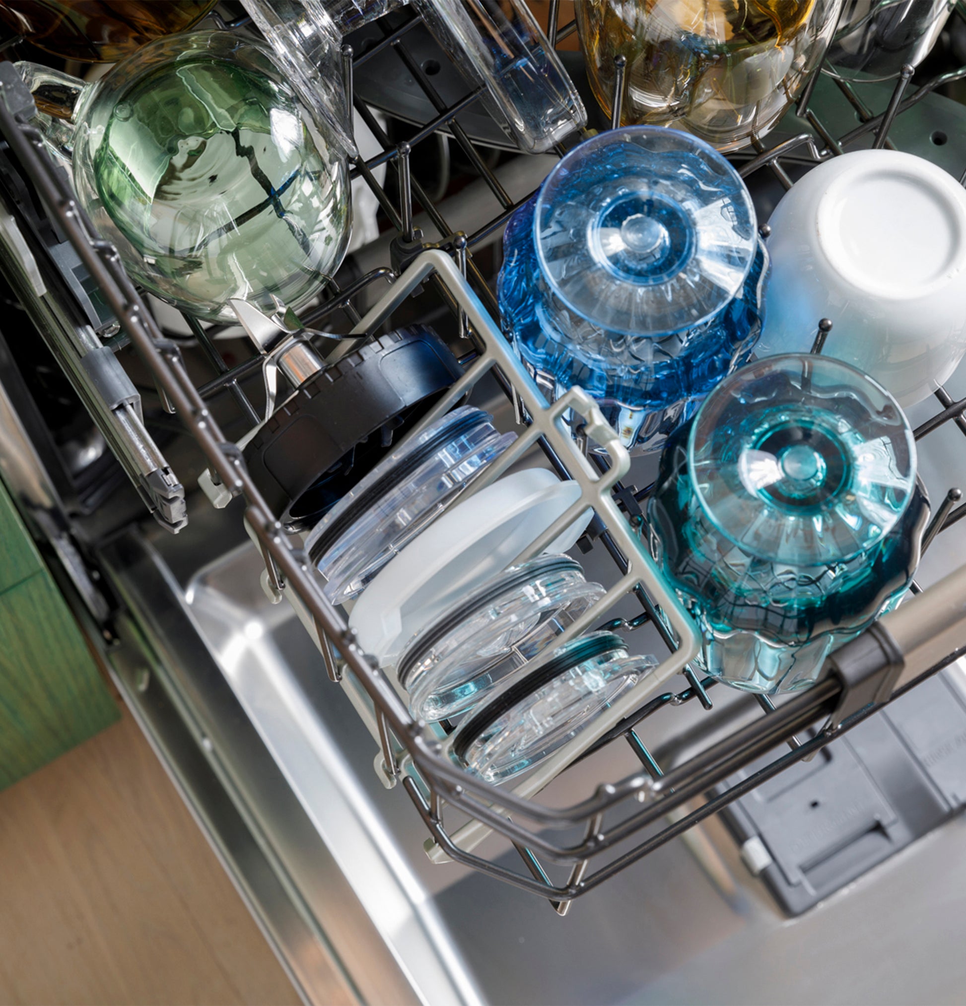 Top rack of dishwasher loaded with glass cups and bowls inside stainless steel appliance from Dishwashers collection.