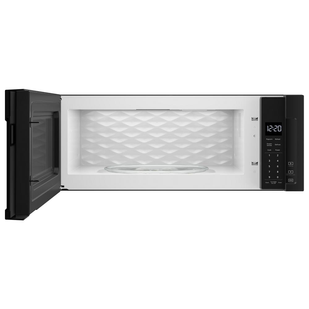 Open low profile microwave with digital control panel and glass turntable in modern kitchen appliance setting
