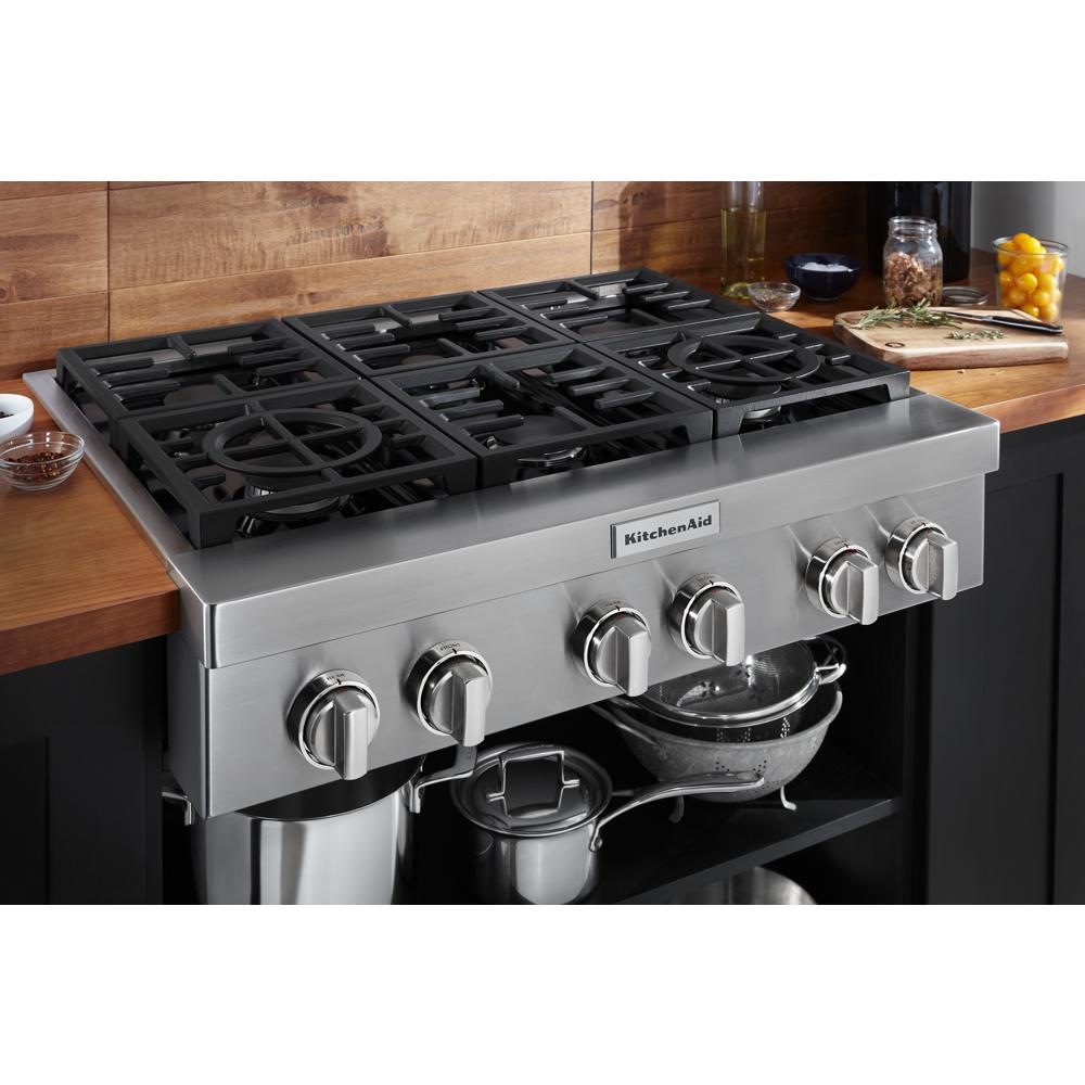 KitchenAid stainless steel 6-burner gas cooktop with control knobs in modern kitchen and appliances collection
