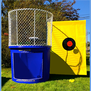 Blue dunk tank with protective metal cage and yellow backdrop featuring a bullseye target, part of party supplies and rental equipment at Hartville Hardware.