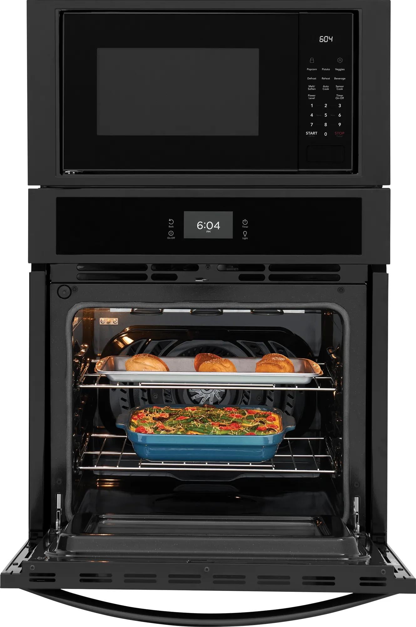 Black built-in electric oven with open door baking casserole and rolls, microwave above in kitchen appliances collection