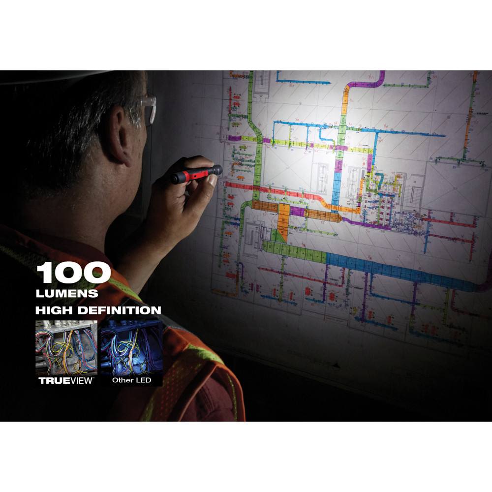 Person holding red and black penlight to illuminate detailed electrical blueprint for home improvement planning