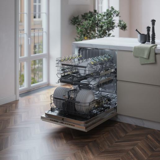 Built-in dishwasher with open door showing organized racks loaded with dishes and glasses in modern kitchen setting
