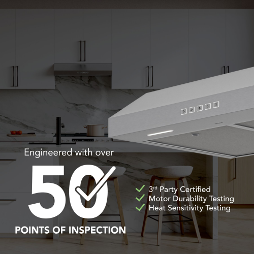 Stainless steel under-cabinet range hood in modern kitchen with white cabinetry and wooden chairs nearby