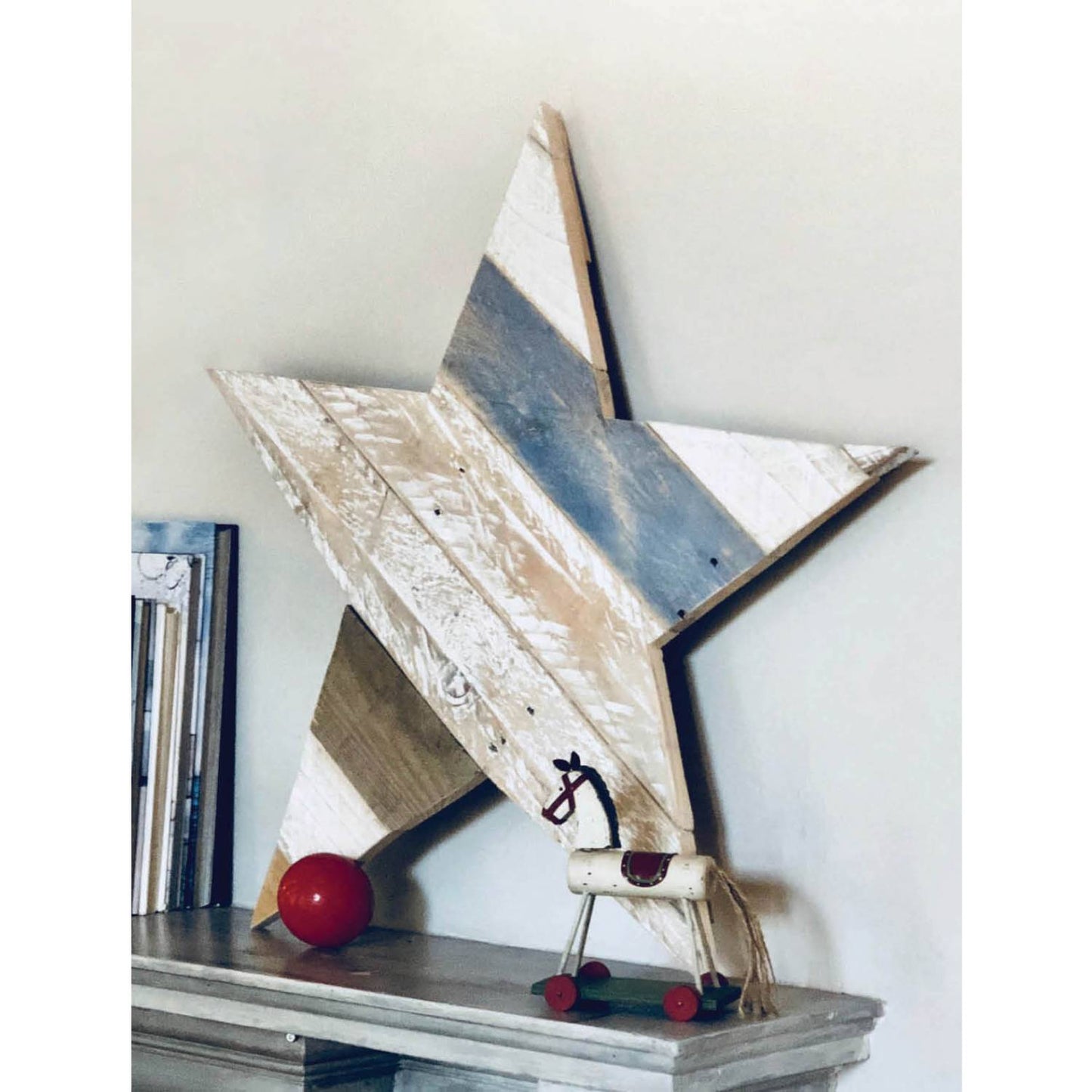 Rustic wooden star decor made from reclaimed pallet boards displayed on a shelf in Books, Under $50 collection