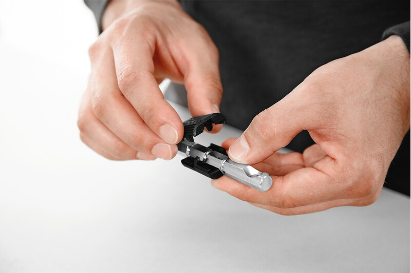 Hands assembling a double bolt connector tool accessory for woodworking and home improvement tasks