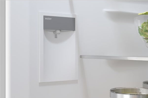 Close-up of built-in water dispenser inside a stainless steel kitchen refrigerator from Bosch Appliances collection