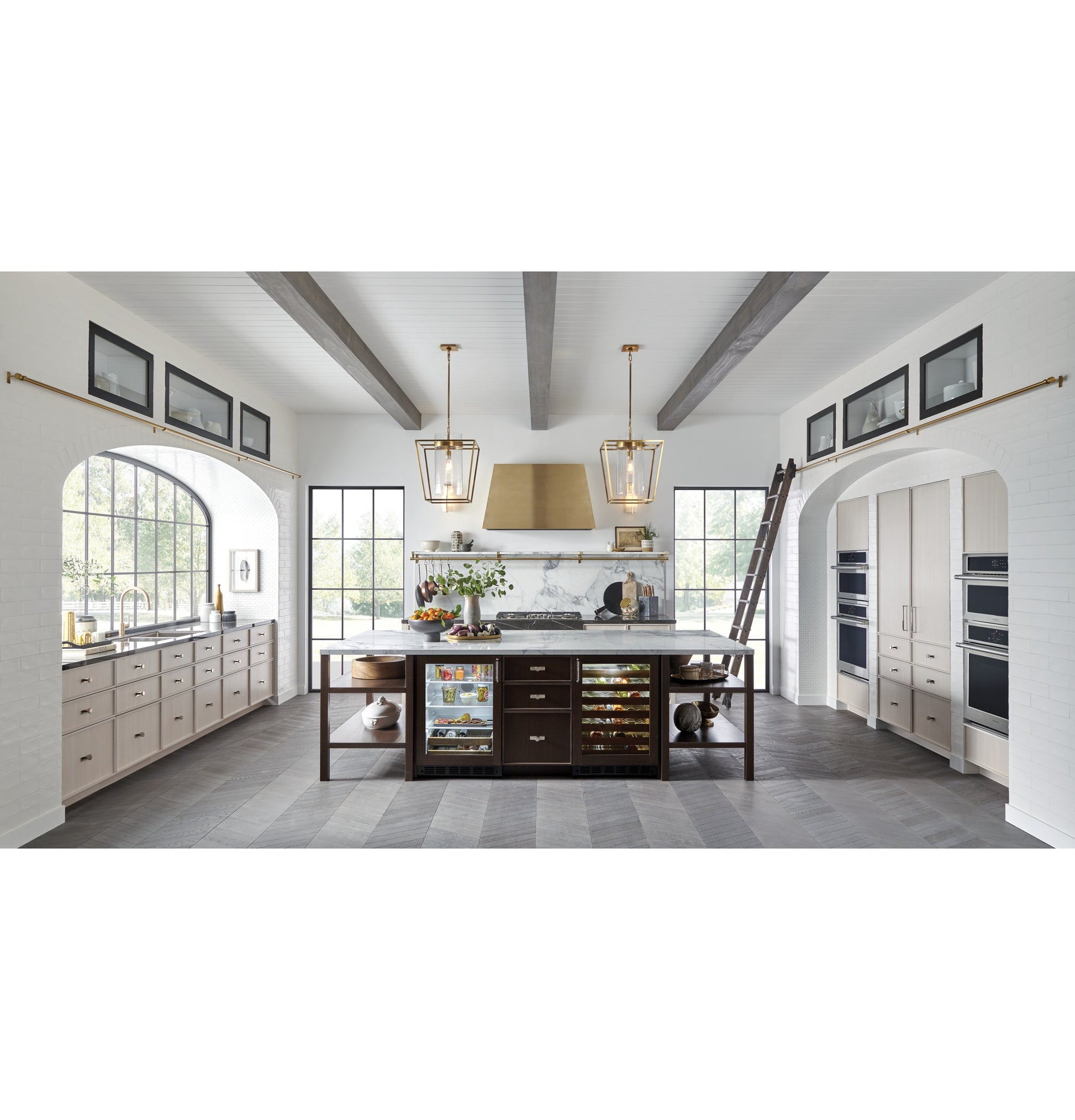 Spacious modern kitchen featuring built-in premium refrigerators, wine storage, and stainless steel ovens in appliances collection