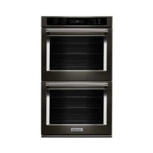 Double wall oven with stainless steel frame and black glass doors, featuring digital controls and sturdy handles for modern kitchen use.