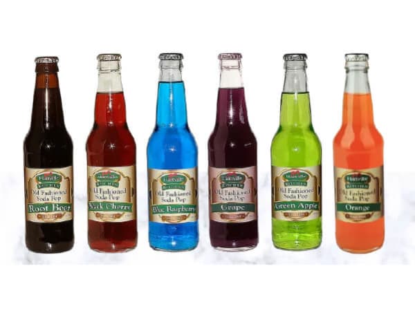 Six glass soda bottles in colors of dark brown, red, bright blue, deep purple, vibrant green, and orange, lined up against a white background.