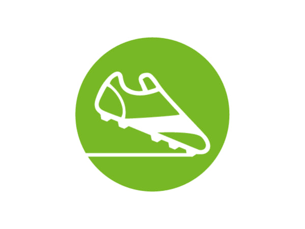 White line icon of a soccer cleat with studs positioned above a horizontal line inside a solid green circular background.